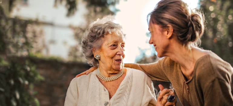 Elderly and young woman talking about hiring senior moving services Philadelphia residents choose year after year