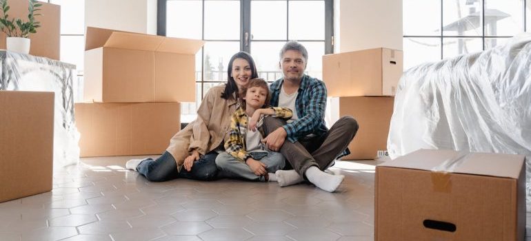 family sitting among boxes
