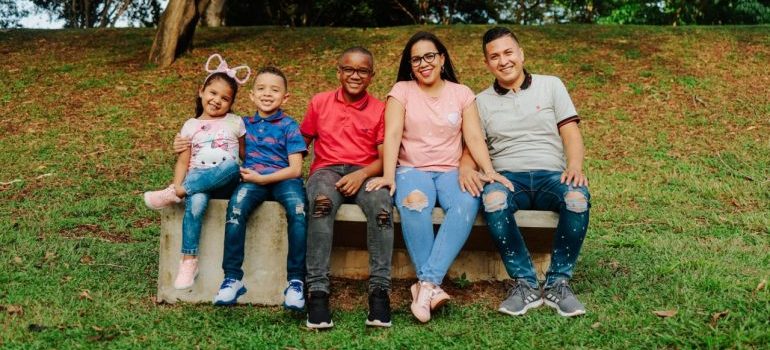 Joyful family enjoying outdoor time on a park bench with smiles and love.