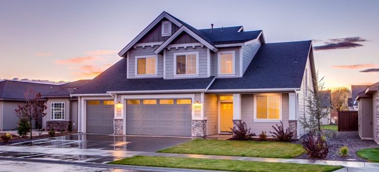 Elegant suburban home with driveway at sunset showcasing modern architecture.