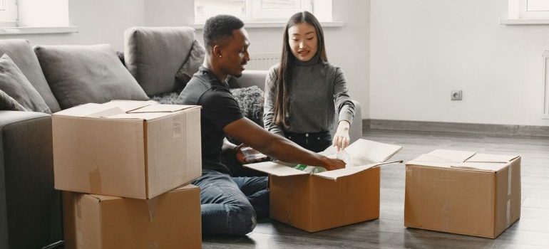 couple unpacking boxes