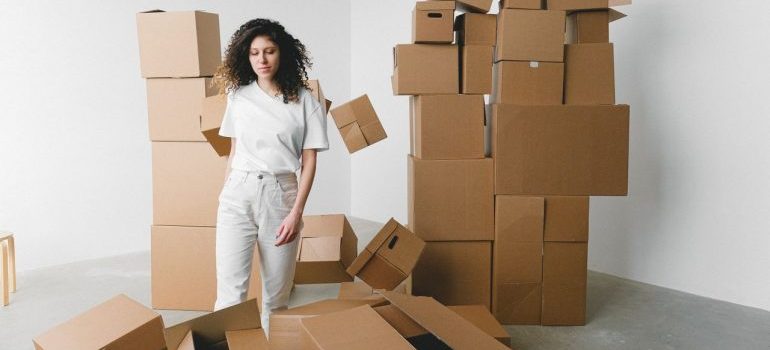 woman standing among boxes