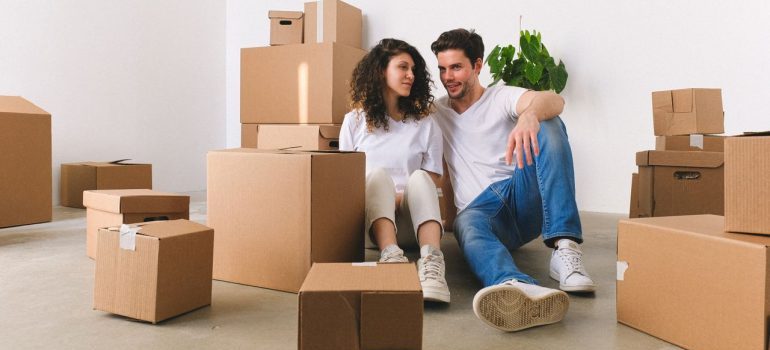 couple sitting among boxes